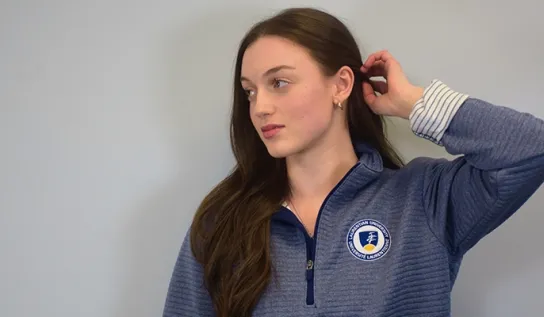 A Laurentian University student modelling Due North's Laurentian University apparel.