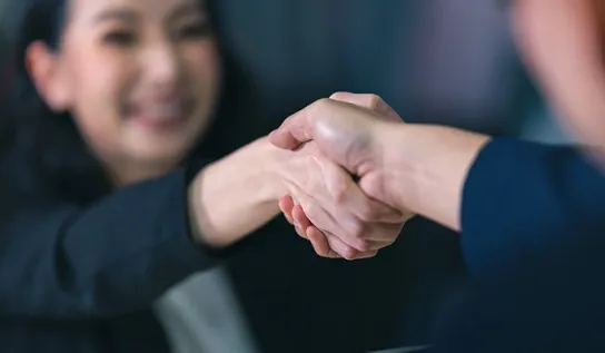 Two business people shaking hands.