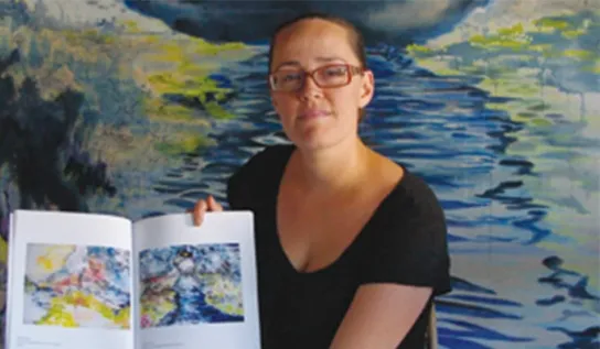 Anong Beam displaying her artwork.