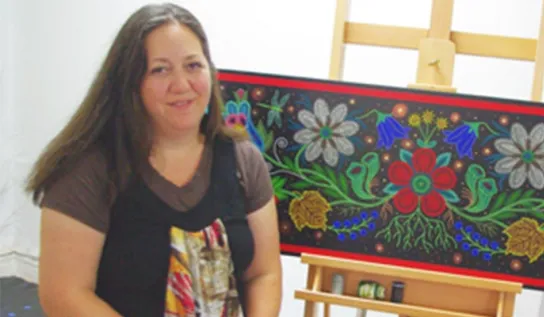 Christi Belcourt displaying her art work.