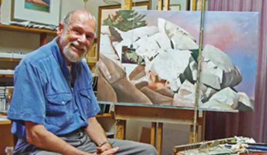 Ivan Wheale showcasing a piece of art of his.