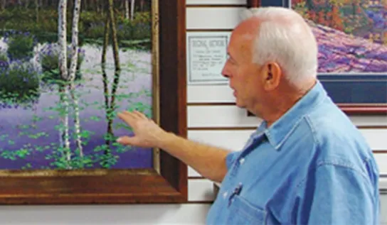 John Stopciati displaying his artwork.