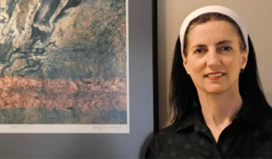 Kathy Browning showcasing a piece of art of hers.