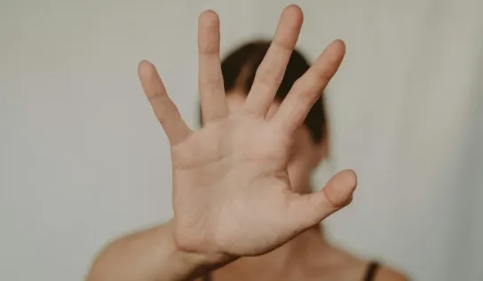 Woman holding hand up to the camera in a stop motion