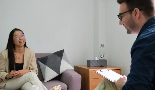 A psychologist giving therapy services to a patient.