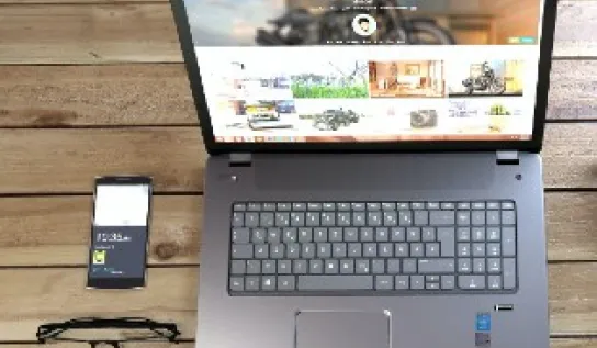 A laptop and a cell phone are side by side