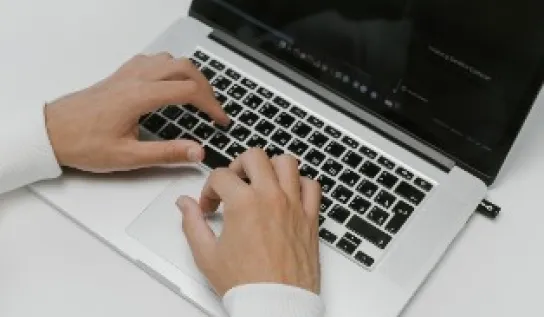 Someone typing on a laptop