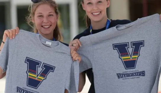 Students holding t-shirts