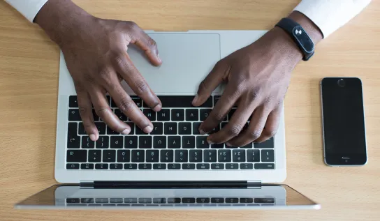 An overhead of someone typing on keyboard