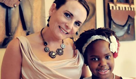 Nicole Tardif and a child smiling 