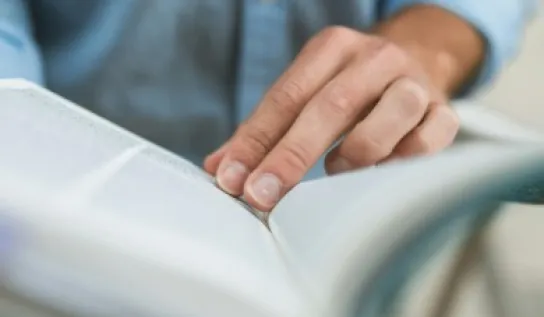 A man reading a thick book
