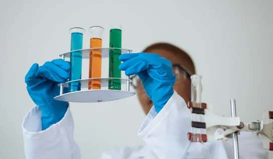 A student looking at test tubes