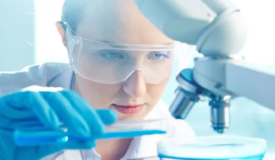 A student looking through a microscope