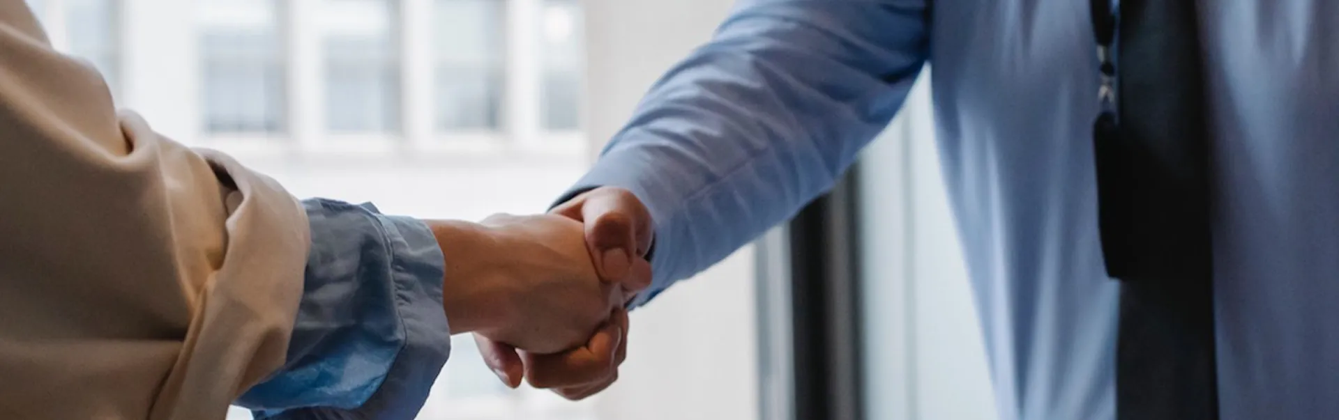 two people shake hands in an office
