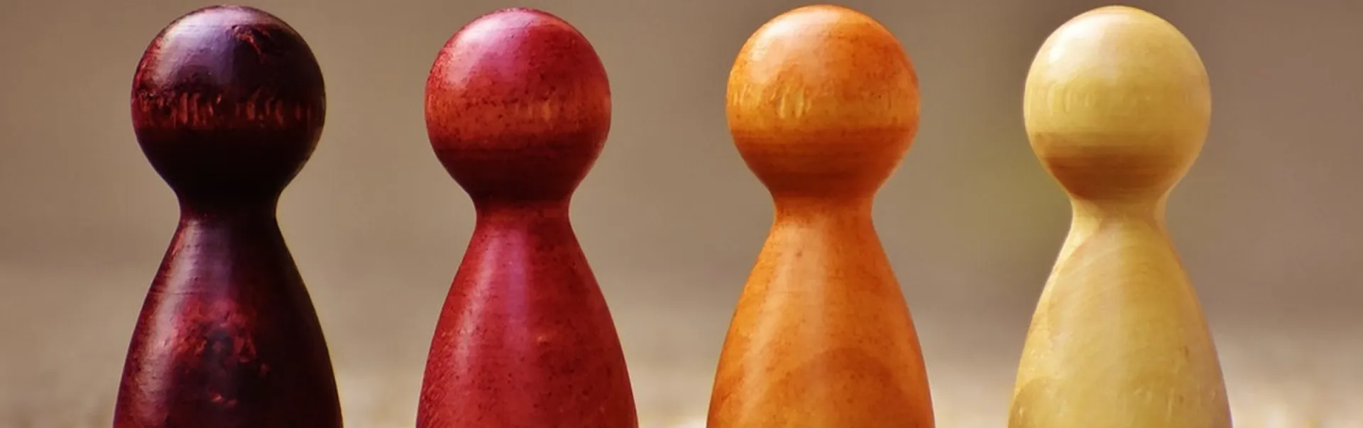 Four different coloured pawns in a row.