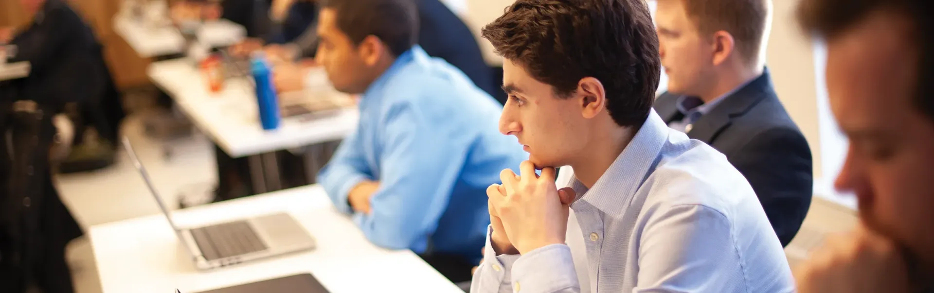 Students with laptops learning in classroom