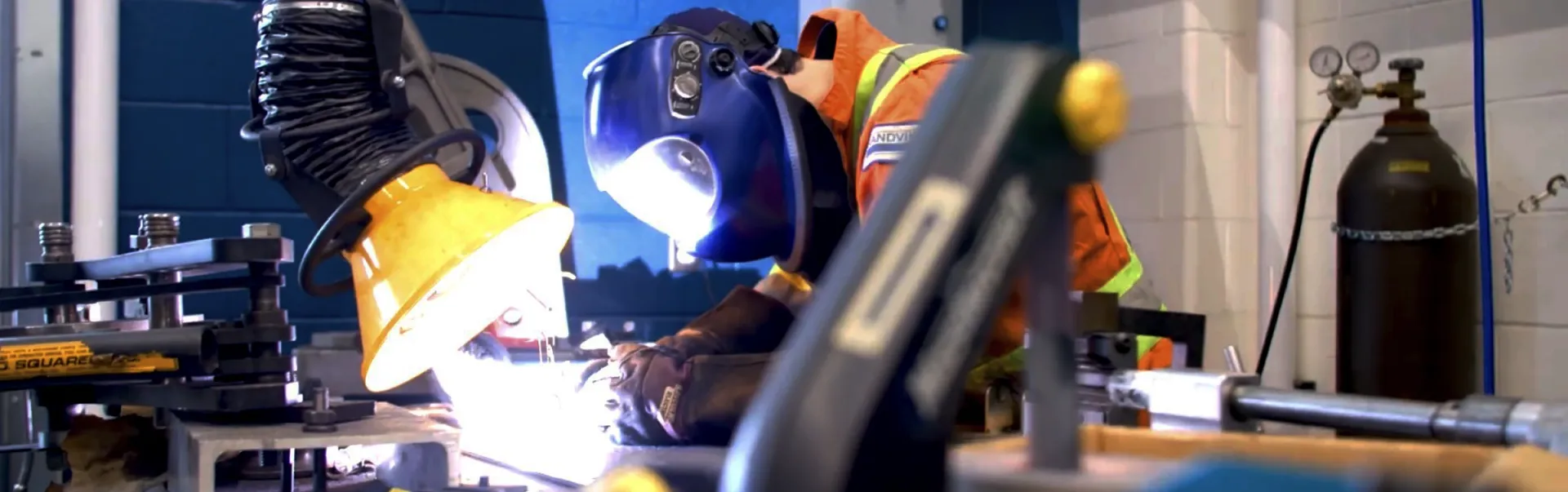 A mechanical engineering student welding.