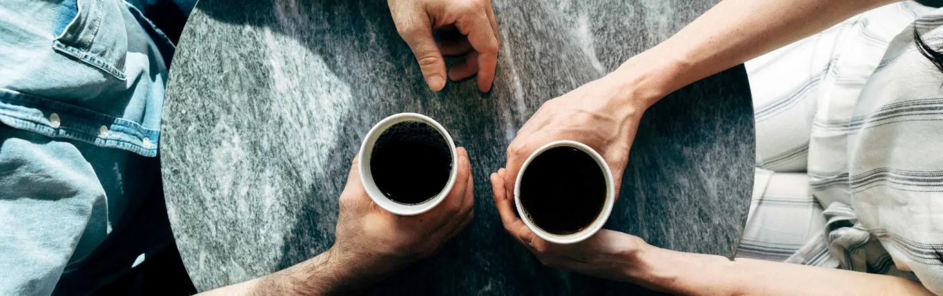 Two people at a table having coffee