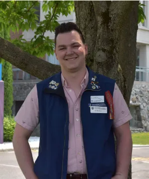 Nicolas standing in front of a tree