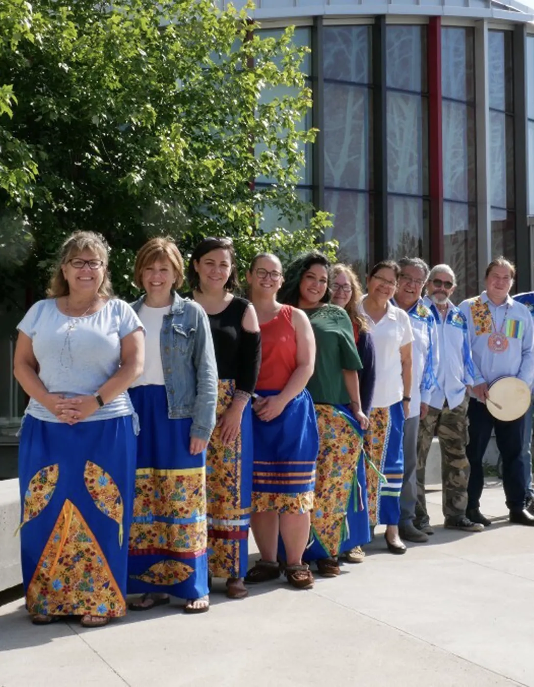 The staff of the Indigenous Student Affairs office lined up outside of the Indigenous Sharing and Learning Centre.