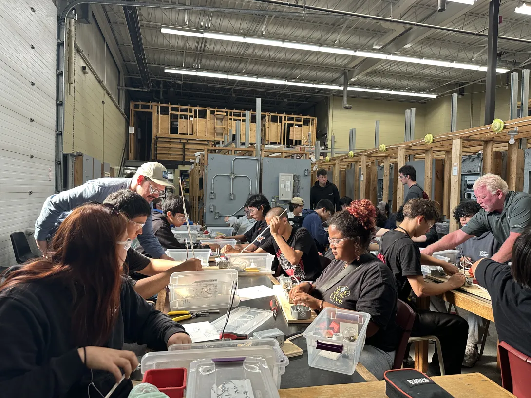 OYEP participants working at tables during a hands-on skilled trades and electrical workshop at Cambrian College. 