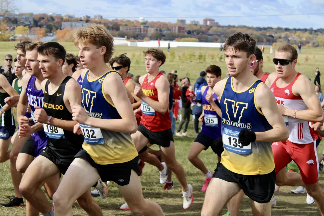 Laurentian Voyageurs runners Braeden Estabrooks (left, bib 132) and Brandon Radey (right, bib 135) lead the pack during an OUA cross-country race.