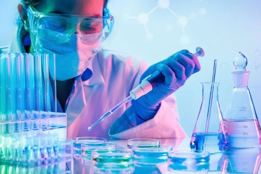 Scientist in a lab safely with a syringe