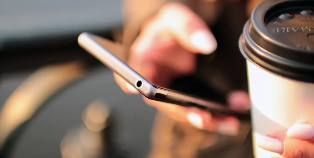 Plan rapproché d'une main utilisant un téléphone intelligent.