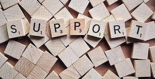 The word " Support" spelled out on wooden cubes